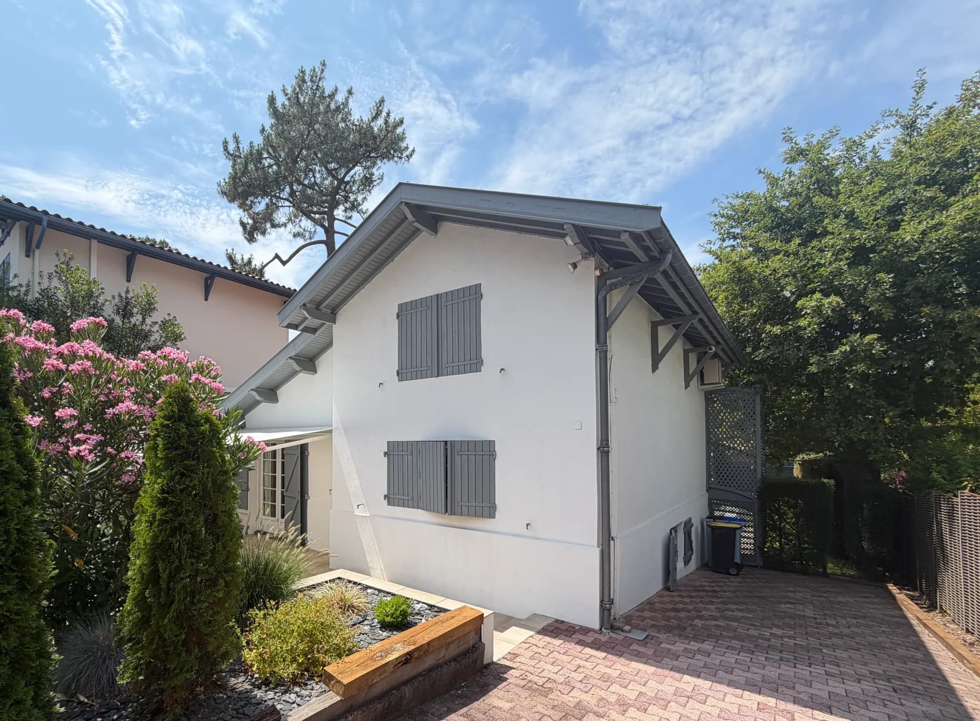 White contemporary house with grey shutters during property diagnostics